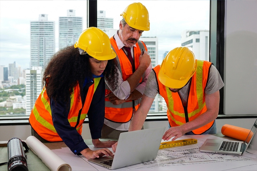 Construction workers and project manager discussing site progress